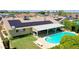 An aerial shot reveals a backyard retreat, complete with a pool, covered patio, and well-maintained lawn at 5349 W Acapulco Ln, Glendale, AZ 85306