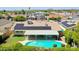 Aerial view of house with a beautiful backyard pool, covered patio, and solar panels at 5349 W Acapulco Ln, Glendale, AZ 85306