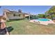 An inviting backyard featuring a pool, lush lawn, and a covered patio perfect for outdoor relaxation and entertainment at 5349 W Acapulco Ln, Glendale, AZ 85306