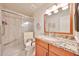 Updated bathroom with a glass-enclosed shower, granite countertop vanity, and modern fixtures at 5349 W Acapulco Ln, Glendale, AZ 85306