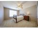 Cozy bedroom with a classic bed frame, complemented by a bedside table and window at 5349 W Acapulco Ln, Glendale, AZ 85306