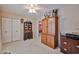 This bedroom features neutral walls and carpet, a ceiling fan and built in wood storage at 5349 W Acapulco Ln, Glendale, AZ 85306