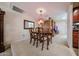 Dining area featuring a wooden table with seating for six, and stylish chandelier at 5349 W Acapulco Ln, Glendale, AZ 85306