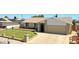 Well-maintained single-story home with a manicured lawn, brick accents, and a two-car garage at 5349 W Acapulco Ln, Glendale, AZ 85306