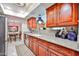 Well-appointed kitchen featuring updated granite counters and rich wood cabinetry at 5349 W Acapulco Ln, Glendale, AZ 85306