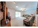 Bright living room with brick fireplace, large windows, and comfortable seating at 5349 W Acapulco Ln, Glendale, AZ 85306