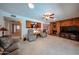 Large living room with multiple seating areas, fireplace, and views into the kitchen and front entryway at 5349 W Acapulco Ln, Glendale, AZ 85306