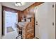 Charming office with wood paneling and a roll-top desk featuring ample storage space at 5349 W Acapulco Ln, Glendale, AZ 85306