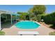 Lush backyard featuring a sparkling swimming pool, covered patio, and mature landscaping, perfect for relaxing and entertaining at 5349 W Acapulco Ln, Glendale, AZ 85306