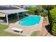 Beautiful backyard featuring a sparkling pool, covered patio, and lush landscaping at 5349 W Acapulco Ln, Glendale, AZ 85306