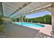 Inviting outdoor pool area with covered patio, lush greenery, and serene ambiance at 5349 W Acapulco Ln, Glendale, AZ 85306