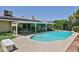 A sparkling blue pool with steps, surrounded by a concrete patio and lush greenery, perfect for summer relaxation at 5349 W Acapulco Ln, Glendale, AZ 85306
