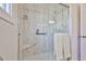 The walk in shower features light tile walls, a glass surround, and built in seating and shelving at 5349 W Acapulco Ln, Glendale, AZ 85306