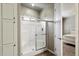 Bright bathroom featuring a walk-in shower with glass doors and tile surround at 650 N Hawes Rd # 3424, Mesa, AZ 85207