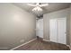 Simple bedroom featuring neutral paint, carpet, a ceiling fan, and a closet at 650 N Hawes Rd # 3424, Mesa, AZ 85207