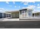 Charming manufactured home with a carport and well-maintained landscaping at 650 N Hawes Rd # 3424, Mesa, AZ 85207