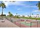 Active pickleball court surrounded by lush landscaping, offering a great recreational and social space at 650 N Hawes Rd # 3424, Mesa, AZ 85207