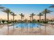 Resort-style pool with lounge chairs and palm trees, perfect for relaxation and enjoying the Arizona sunshine at 650 N Hawes Rd # 3424, Mesa, AZ 85207