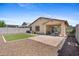 Cozy backyard featuring a patio, artificial turf, and desert landscaping, perfect for outdoor entertaining at 654 E Buckingham Ave, Gilbert, AZ 85297