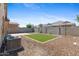 Serene backyard showcasing a well-maintained artificial turf area and desert landscaping at 654 E Buckingham Ave, Gilbert, AZ 85297