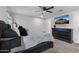 Well-lit bedroom features a plush, tufted headboard bed and dark dresser with a mounted TV at 654 E Buckingham Ave, Gilbert, AZ 85297