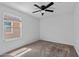 A clean, bright bedroom features a neutral carpet and a large window at 654 E Buckingham Ave, Gilbert, AZ 85297