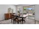 Cozy dining area with dark wood furniture, a decorative mirror, and a view of the outdoor patio at 654 E Buckingham Ave, Gilbert, AZ 85297