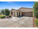 Inviting single-story home with a spacious driveway, desert landscaping, and a charming entryway at 654 E Buckingham Ave, Gilbert, AZ 85297