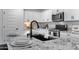Bright kitchen features granite countertops, a stainless steel oven and a sleek black kitchen sink at 654 E Buckingham Ave, Gilbert, AZ 85297