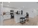 Modern kitchen featuring white cabinetry, granite countertops, stainless steel appliances, and a breakfast bar at 654 E Buckingham Ave, Gilbert, AZ 85297