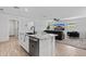 Modern kitchen with stainless steel appliances, granite counters and an island with a sink at 654 E Buckingham Ave, Gilbert, AZ 85297