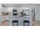 Bright kitchen features granite countertops, stainless steel appliances, and a kitchen island with seating at 654 E Buckingham Ave, Gilbert, AZ 85297