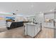 Modern kitchen flows into the living room with granite counters and stainless steel appliances at 654 E Buckingham Ave, Gilbert, AZ 85297