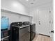 Laundry room features modern washer and dryer units, complemented by a wall-mounted shelf at 654 E Buckingham Ave, Gilbert, AZ 85297