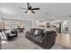 Open-concept living room with a modern kitchen, comfortable seating, and abundant natural light at 654 E Buckingham Ave, Gilbert, AZ 85297