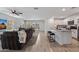 Bright and open-concept living area with tiled floors, a kitchen island, and a comfortable seating arrangement at 654 E Buckingham Ave, Gilbert, AZ 85297