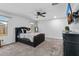 Spacious main bedroom with a ceiling fan, TV, and natural light at 654 E Buckingham Ave, Gilbert, AZ 85297