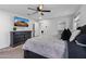 Spacious main bedroom with a ceiling fan and television at 654 E Buckingham Ave, Gilbert, AZ 85297