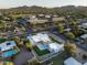 Birds-eye view featuring the modern home, pool and community, framed by distant mountains at 6702 E Cholla St, Scottsdale, AZ 85254
