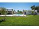 Spacious backyard with a pool, lounge area, and lush green lawn, ideal for outdoor activities at 6702 E Cholla St, Scottsdale, AZ 85254