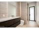 Modern bathroom featuring tile accent wall, dark wood vanity and glass walk-in shower at 6702 E Cholla St, Scottsdale, AZ 85254