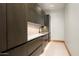 Functional butler's pantry with under-cabinet lighting, marble countertops, and custom cabinetry at 6702 E Cholla St, Scottsdale, AZ 85254