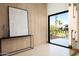 Stylish entryway featuring textured walls, modern art, and a view of the landscaped front yard at 6702 E Cholla St, Scottsdale, AZ 85254