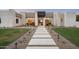 Stunning modern home featuring desert landscaping and a striking walkway to the front entrance at 6702 E Cholla St, Scottsdale, AZ 85254