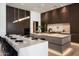 Contemporary kitchen with custom cabinetry and a spacious island, perfect for cooking and dining at 6702 E Cholla St, Scottsdale, AZ 85254