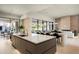 Open-concept kitchen featuring an island with bar seating, modern appliances, and an inviting atmosphere at 6702 E Cholla St, Scottsdale, AZ 85254
