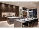 Sleek, modern kitchen with an island, bar seating, and high-end stainless steel appliances at 6702 E Cholla St, Scottsdale, AZ 85254