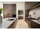 Contemporary kitchen showcasing dark wood cabinetry, a marble countertop island, and modern fixtures at 6702 E Cholla St, Scottsdale, AZ 85254