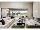 Bright living room featuring a fireplace, comfortable seating, and access to the outdoor pool area at 6702 E Cholla St, Scottsdale, AZ 85254