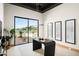 Stylish home office with large windows, modern desk, and a serene outdoor view at 6702 E Cholla St, Scottsdale, AZ 85254